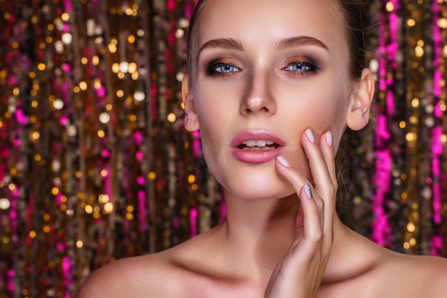 Beauty portrait of a high fashion woman in colorful bright neon lights posing on colourful vivid seq