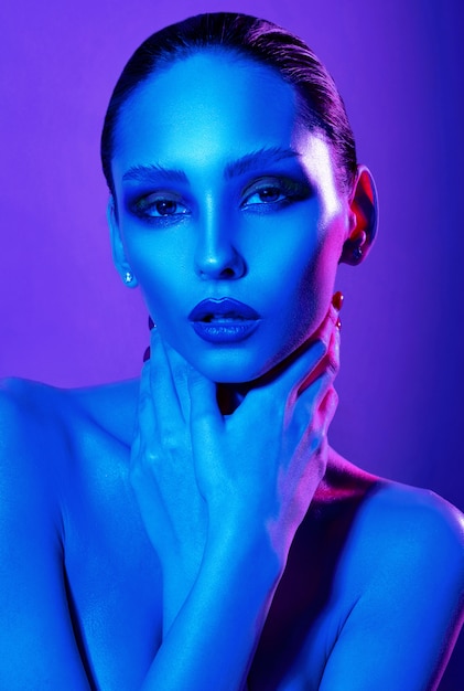 Beauty portrait of woman in neon lights