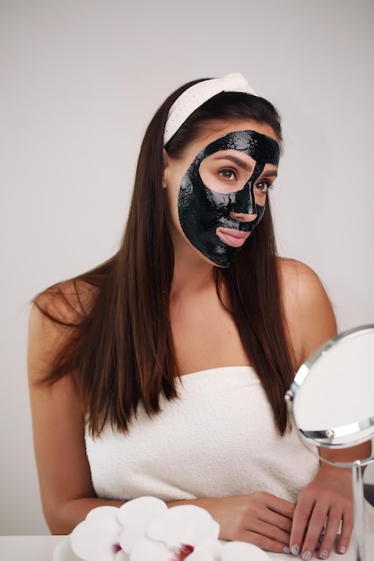 Beauty portrait woman skin care health black mask white background close up