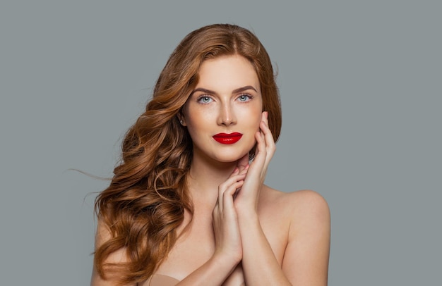 Beauty portrait of woman with long curly beautiful ginger hair