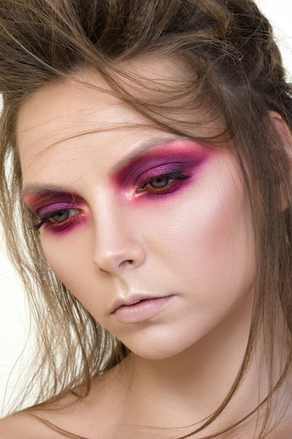 Beauty portrait of young pretty girl with fashion make-up. Modern smokey eyes makeup.