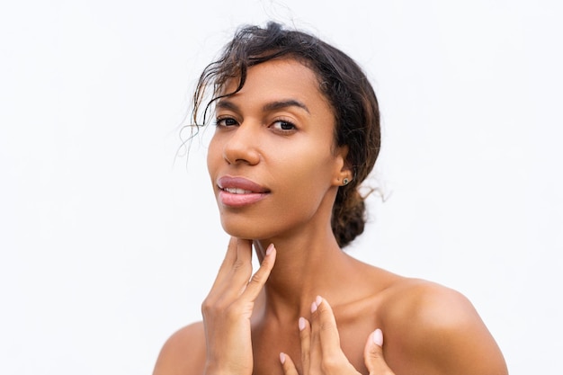 Beauty portrait of young topless african american woman with bare shoulders on white background with