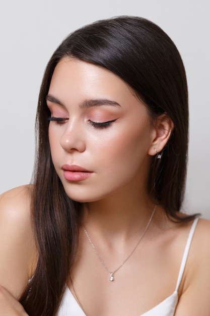 Beauty portrait of a young woman brunette girl on a white background