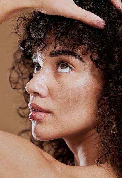 Beauty skincare and natural hair of a young woman in studio for cosmetics makeup and hair care for health and wellness Face glow of a female after a facial with dermatology cream for acne skin