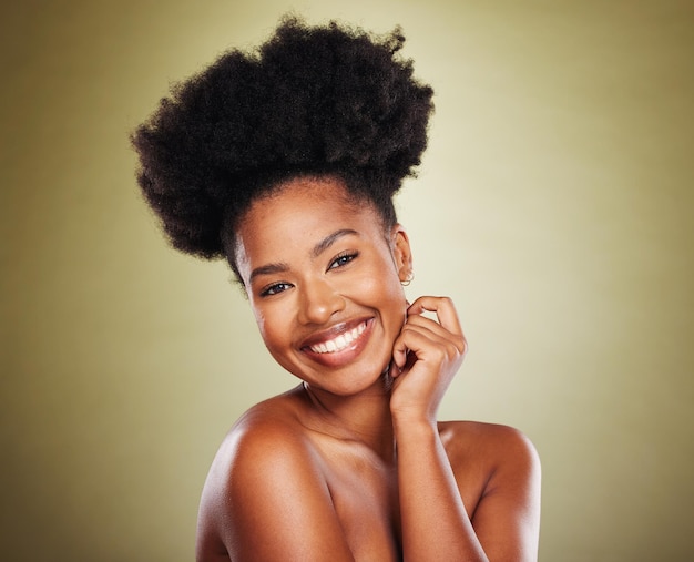 Beauty skincare and smile of black woman with natural hair or afro on green studio background for health and wellness of skin and body Portrait of model happy about cosmetic makeup and dermatology