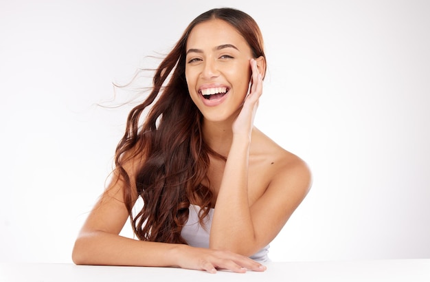 Beauty skincare and woman in studio with hair care cosmetics and natural makeup on white background or marketing space Happy portrait and teeth of young model for beauty salon mockup advertising