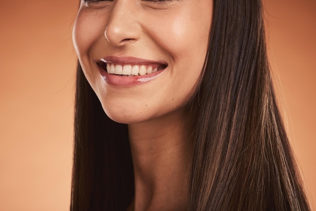 Beauty smile and teeth portrait of woman in studio with luxury makeup and dental care for healthy and clean mouth Health wellness and beautiful happy model girl with big smile on brown background