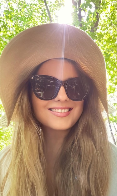 Beauty summer holiday and fashion face portrait of happy woman wearing hat and sunglasses for skincare cosmetics sunscreen spf lifestyle look idea