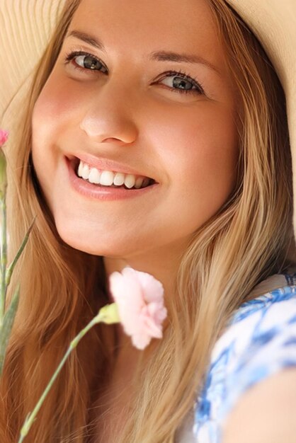 Beauty summer and skincare happy smiling woman in hat with flower as cosmetics wellness and lifestyle fashion