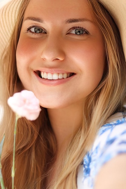 Beauty summer and skincare happy smiling woman in hat with flower as cosmetics wellness and lifestyle fashion