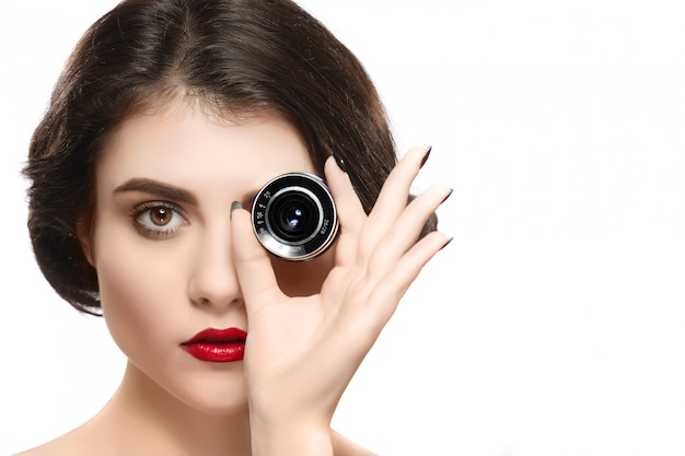 Beauty woman portrait holding camera lens on eye