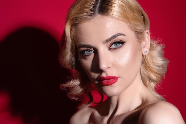 Beauty woman with fashion eyes make up red lipstick on plump lips blonde hair close up face fashion