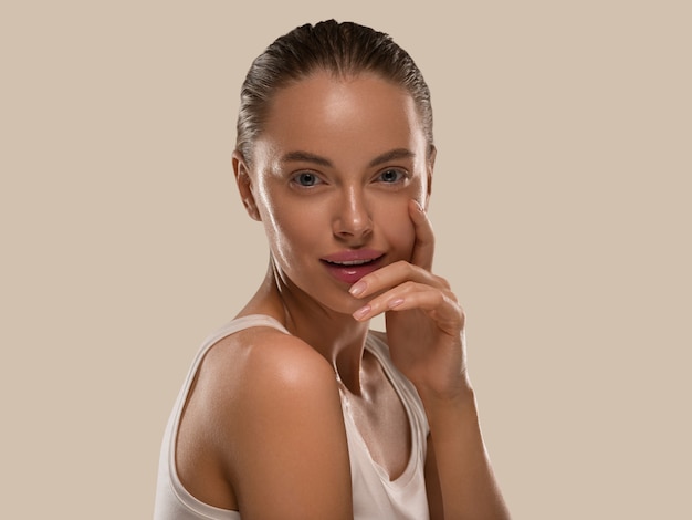 Beauty woman with hands healthy  natural make up clean fresh skin  concept color background brown