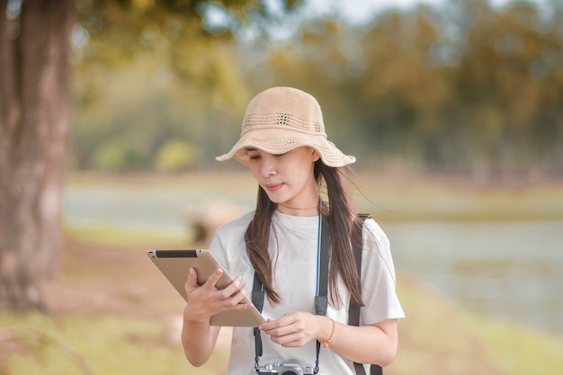 Beauty women holding tablet with camera travel take photo