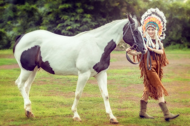 Beauty young asian girl with native american woman and walking with american paint horse in Thailand.