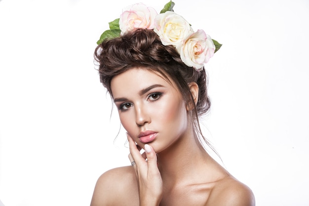 Beauty young girl, clean skin, beautiful make-up, hairstyle braids and rose flowers in hair.