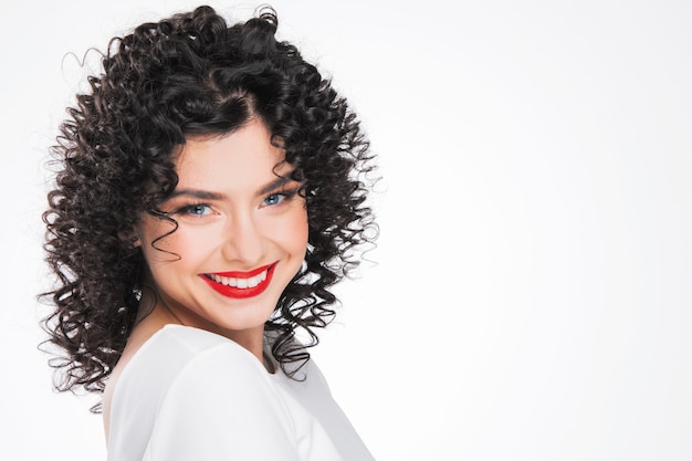 Beauty young woman portrait isolated on white surface. Girl with black curly hair. Hairstyle. Haircut