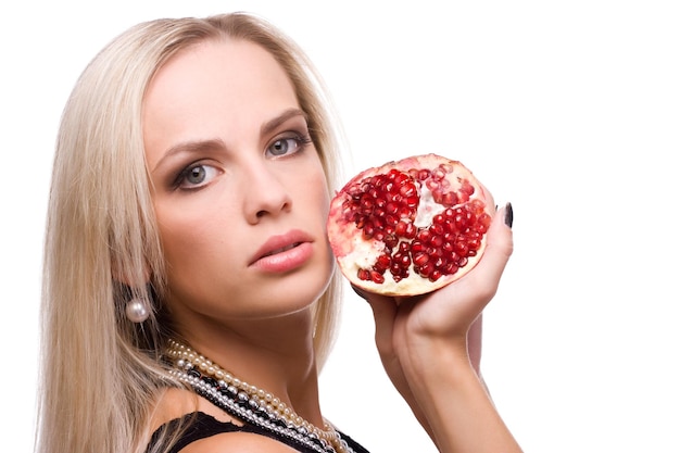 Beauty young woman with fresh red pomegranate