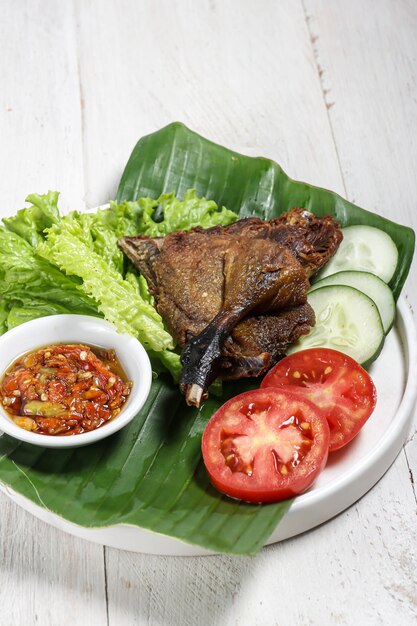 Bebek Goreng sambal bawang deep fried duck served with sambal garlic chilli sauce and vegetables