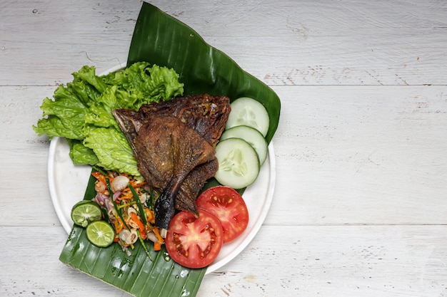 Bebek Goreng sambal matah deep fried duck served with sambal and fresh vegetables