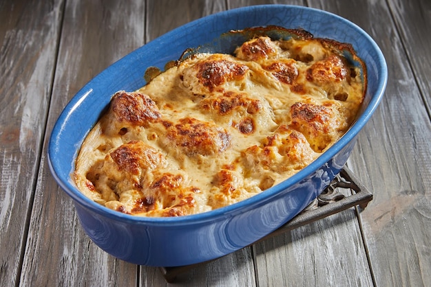 Bechamel sauce cauliflower in ceramic bowl after baking in the oven