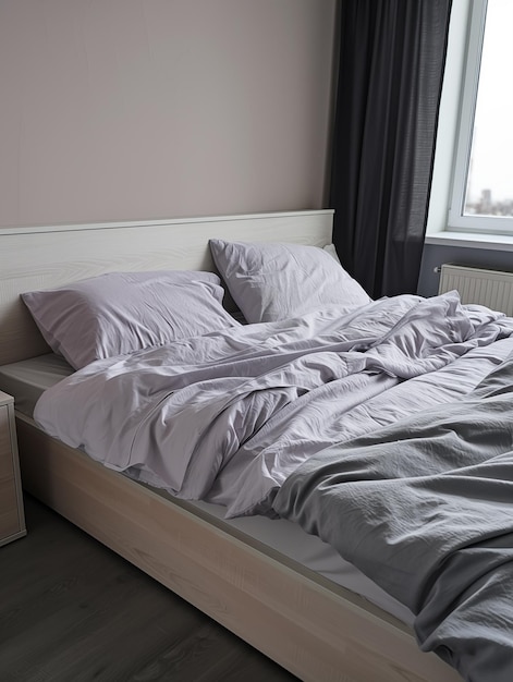 Bed with lavender and gray bedding linen in modern bedroom with natural light from window