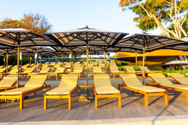 bedpool with umbrella around swimming pool in hotel resort