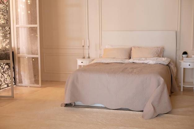 bedroom interior with Coffee table and Cozy bed with light linens and blanket