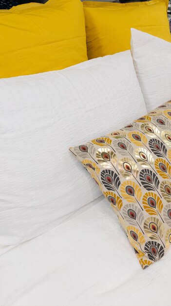 Bedroom interior yellow and white golden pillows on bed