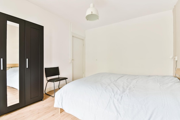 A bedroom in the light of day with a synthphone cover