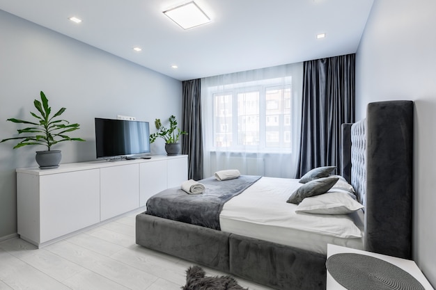 Bedroom in a small apartment with a large bed and white walls