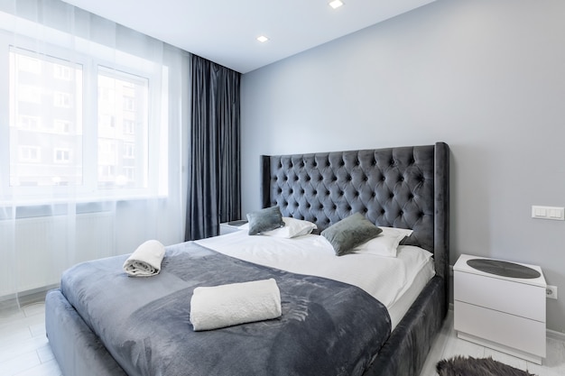 Bedroom in a small apartment with a large bed and white walls