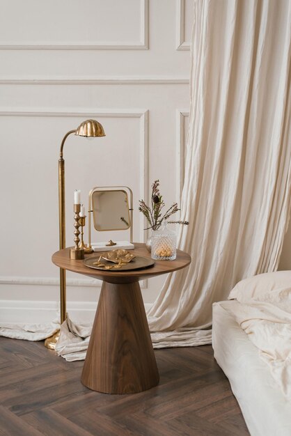 Bedside table with accessories in the bedroom by the bed in white tones Scandinavian interior