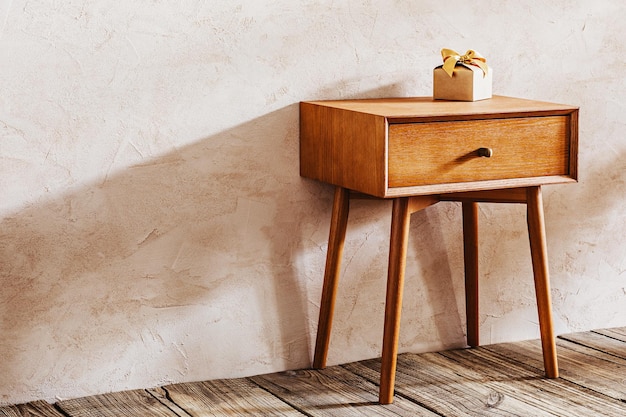 A bedside table with a gift box on it