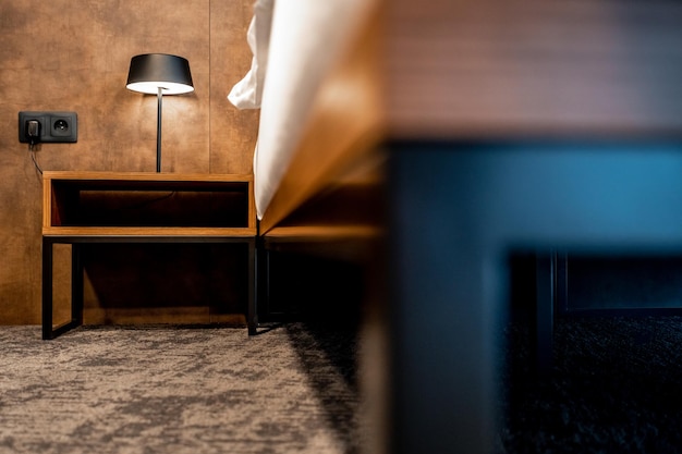 Bedside table with lamp in hotel room