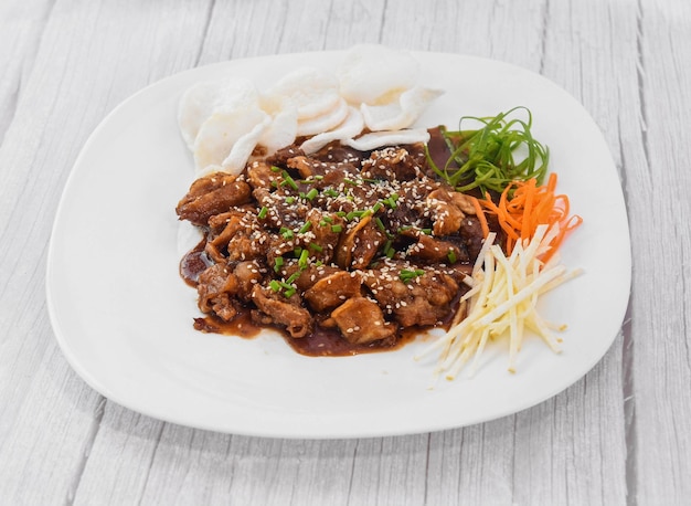 Beef Bulgogi served in dish isolated on grey wooden background side view of fastfood