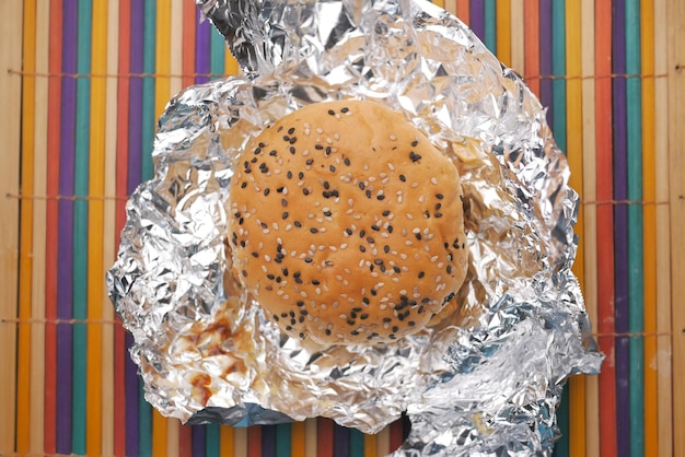 Beef burger and french fries in a takeaway paper box on table