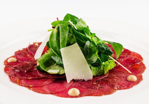 Beef carpaccio with parmesan cheese close up