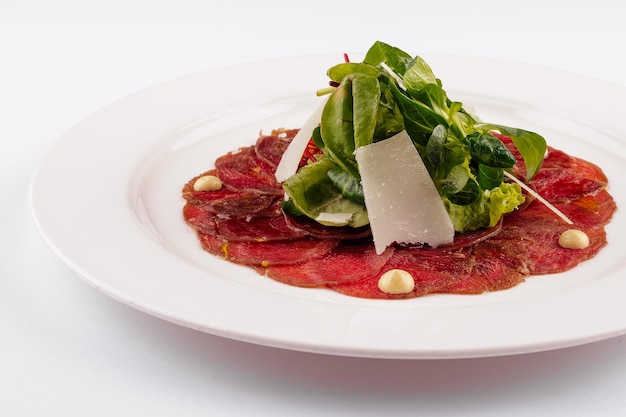 Beef carpaccio with parmesan cheese close up