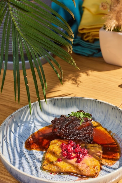 Beef cheek steak caramelized in wine sauce with chanterelles in a plate