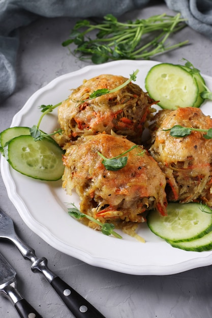 Beef cutlets with potatoes served with cucumber and peas