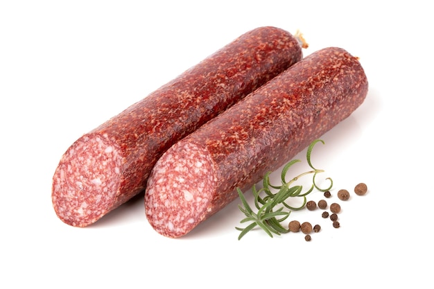 Beef Dried smoked Salami sausage with rosemary branch and pepper peas in closeup isolated on a white background