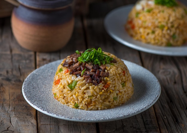 Beef Fried Rice served in a dish isolated on wooden board side view