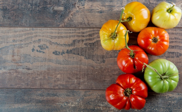 Beef heart tomatoes in the basket on wooden background