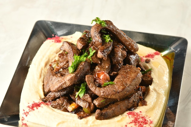 beef liver, served dry or with curry in a bowl, karahi or plate