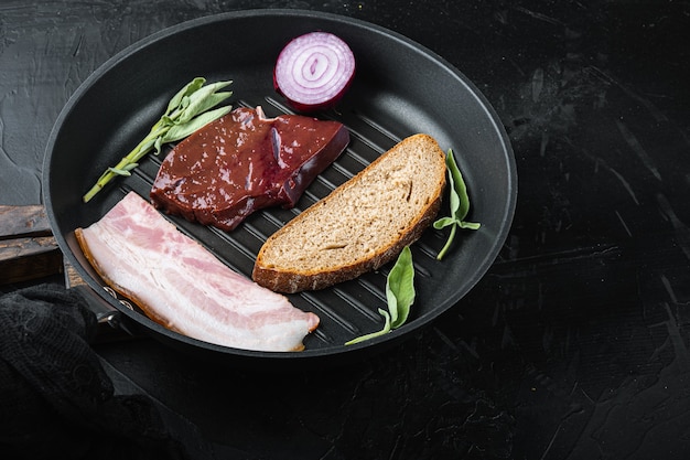 Beef liver sliced with bacon on a grill pan