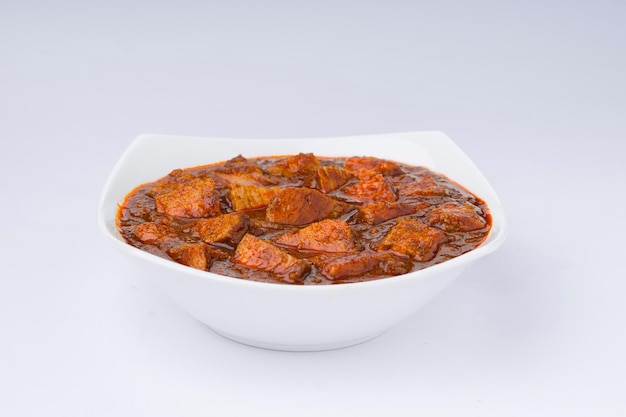 Beef masala or curry homemade recipe arranged in white bowl  with white background