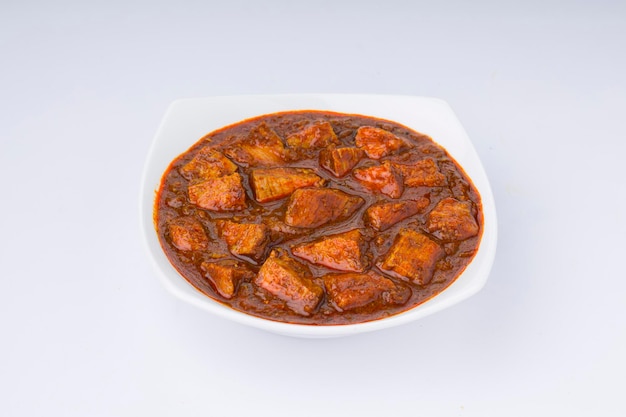 Beef masala or curry homemade recipe arranged in white bowl  with white background