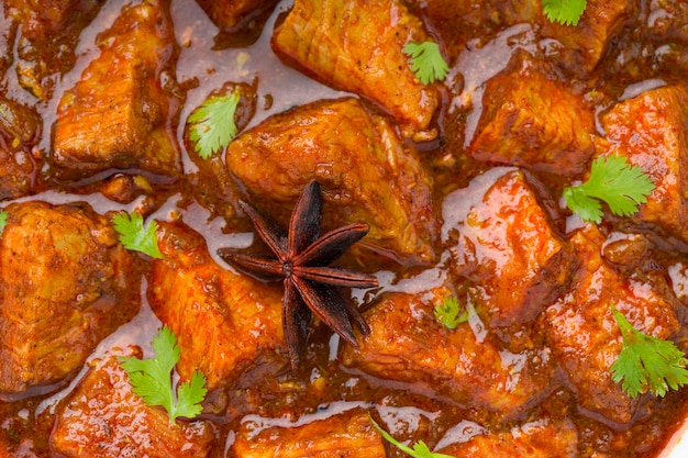 Beef masala or curry homemade recipe arranged in white bowl  with white background