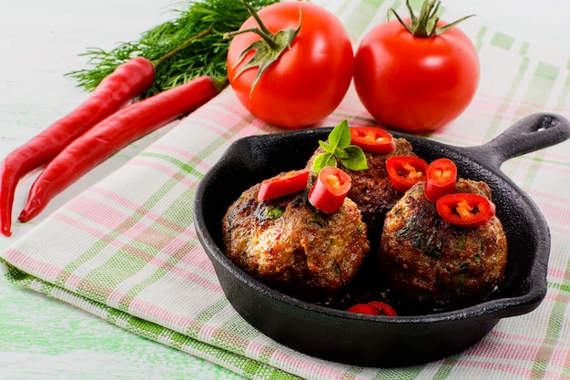 Beef meatballs with chili pepper  served in skillet 